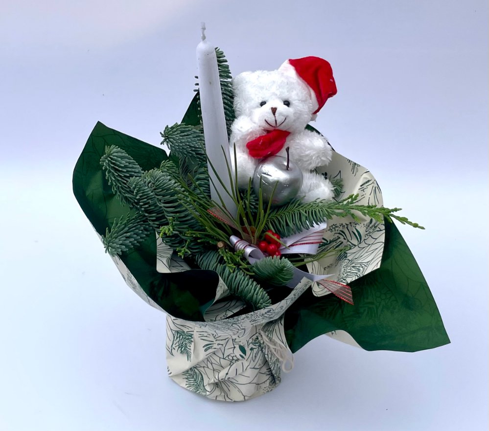 Foto Composizione natalizia con peluche e candela